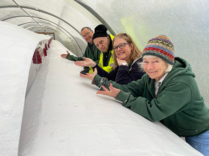 The team celebrating the completion of the royal carriage roof