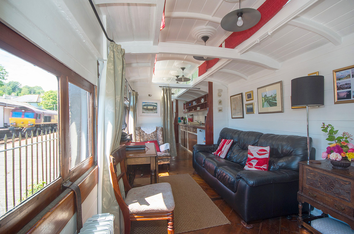 The Travelling Post Office living area with a train in the window